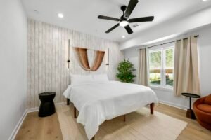 Above All Handyman bedroom remodel with wood accent wall, modern lighting, and new flooring at 1498 Murphy Ave, Atlanta, GA.