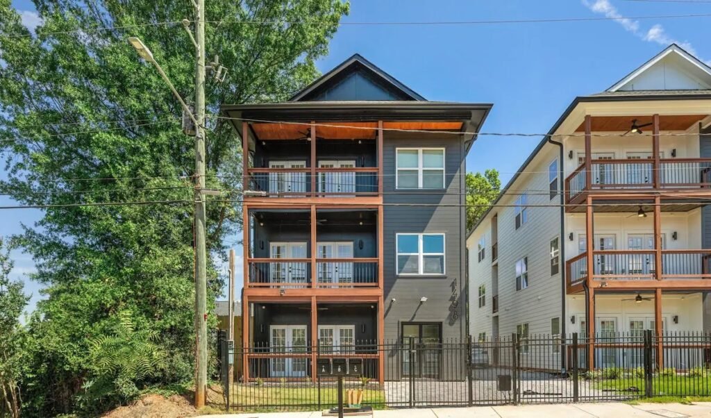 best-handyman-services-atl/painting 1 best handyman services atl painting Modern three-story apartment building with wood balconies and gray siding at 1498 Murphy Ave SW, Atlanta GA, across from Tyler Perry Studios.