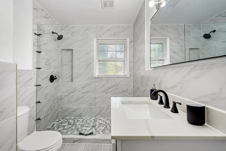 Handyman Plumbing 1 Handyman Plumbing Atlanta – modern bathroom remodel at 2612 Clairmont Rd featuring new fixtures, glass shower, and updated vanity by Above All Handyman.