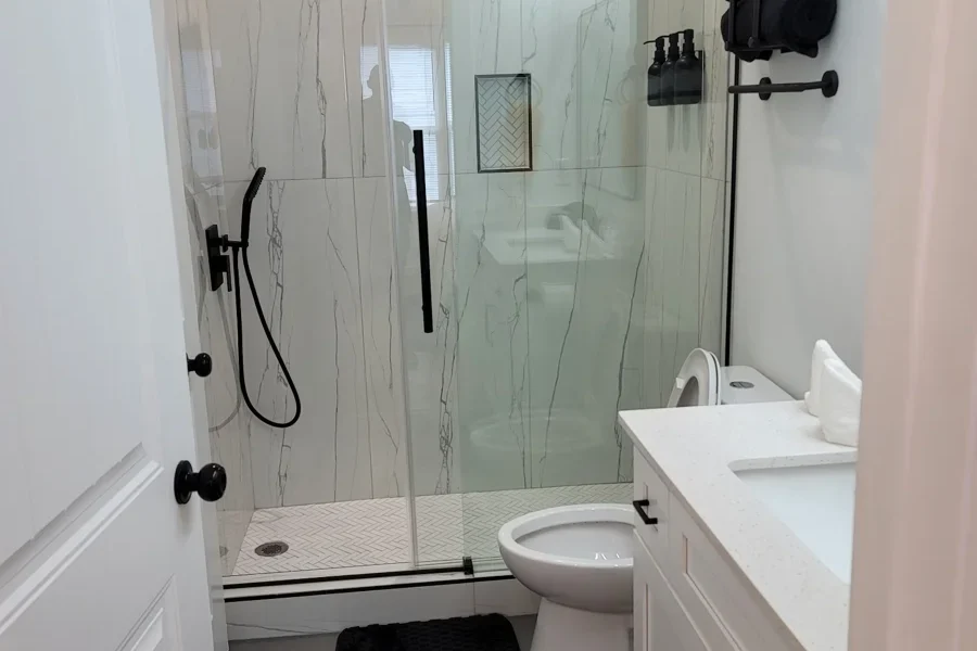 Local Handyman Atlanta project – Above All Handyman transformed this bathroom with a modern glass shower, tile finishes, and a new vanity
